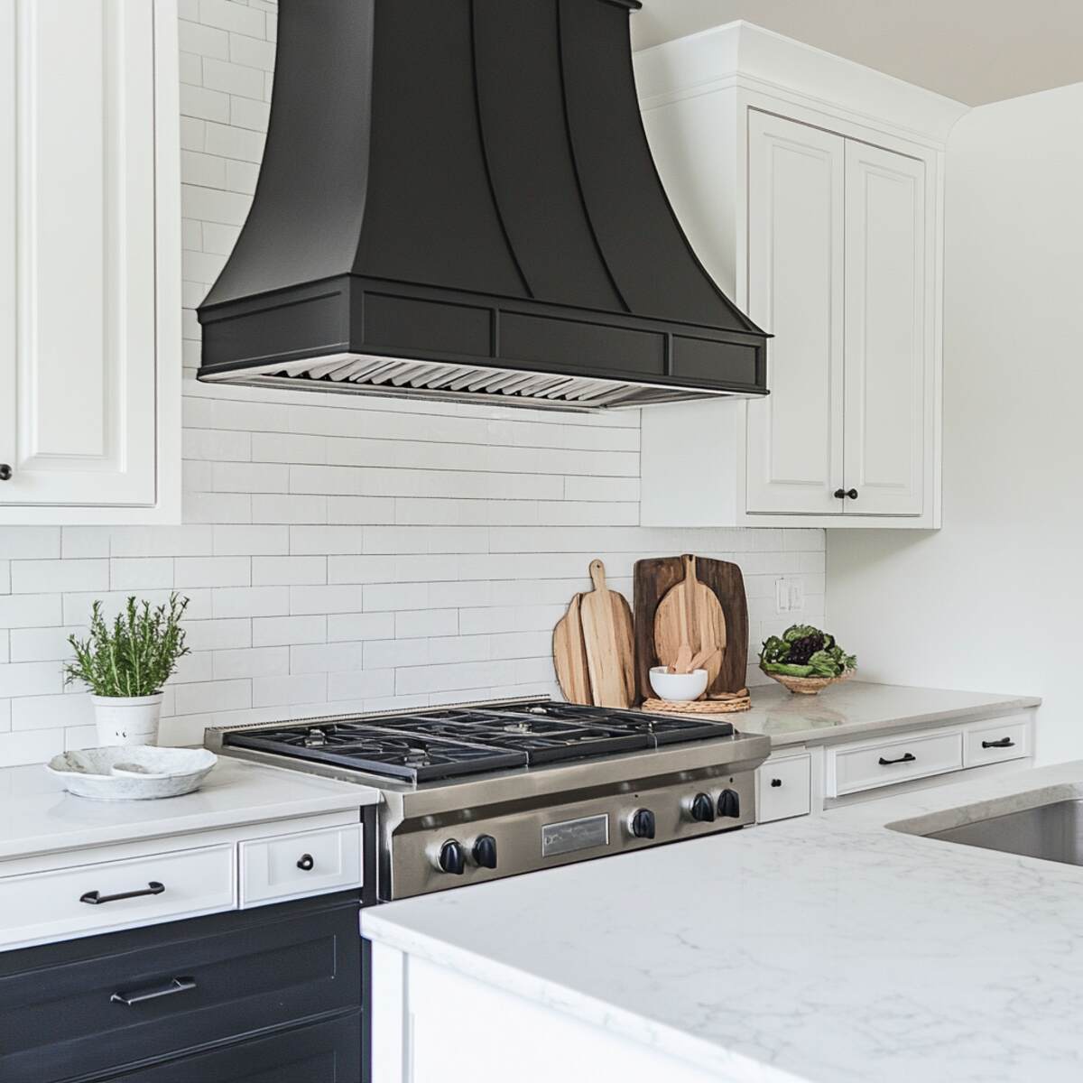 Black range hood with white surrounding cabinetry