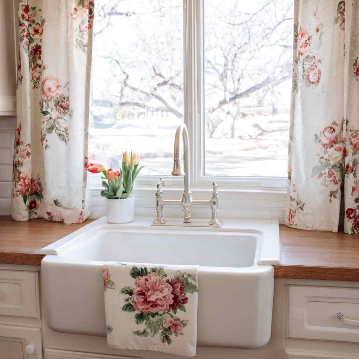 White Farmhouse Sink with Floral Window Curtains